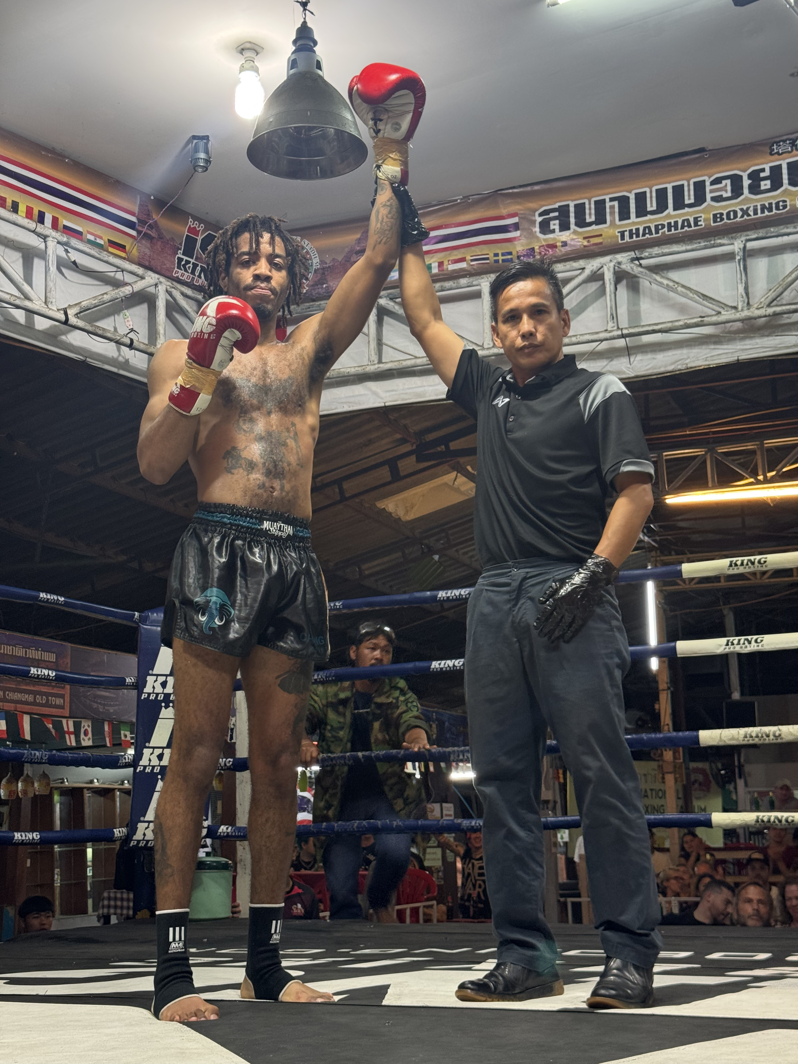 Fighter doing padwork with coach in the gym ring