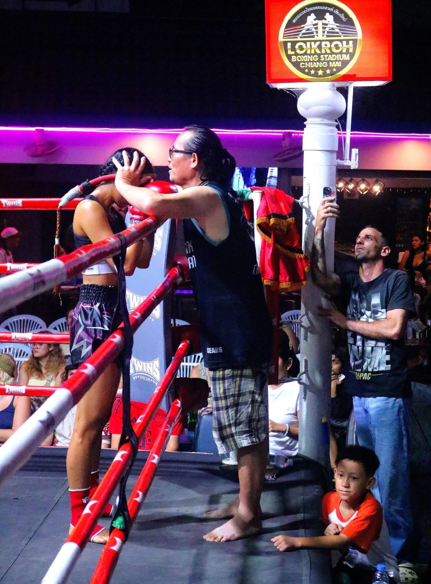 Head coach giving a thumbs up ringside at the stadium
