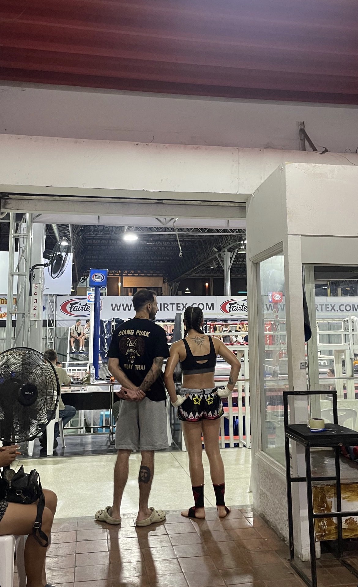 Coach giving water to fighter between rounds in the corner