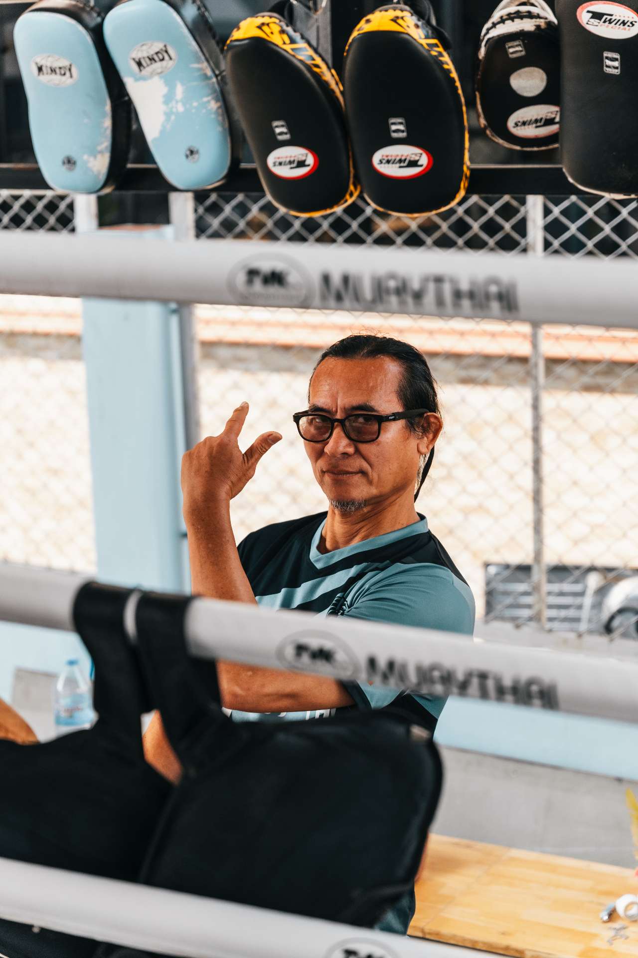 Head coach relaxing ringside at the gym