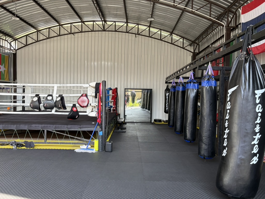 The boxing ring with a line of bags in the background