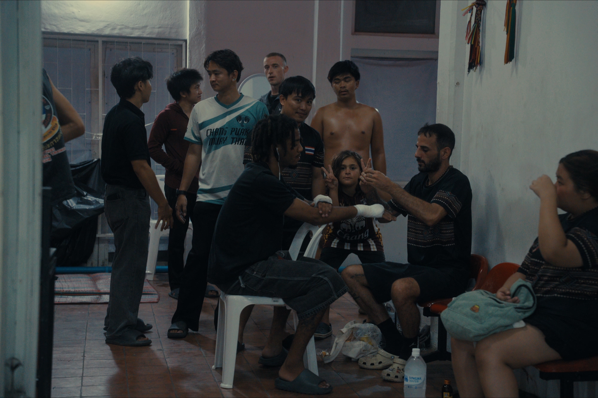 Fighter getting hands wrapped in gauze in the pre-fight preparation room
