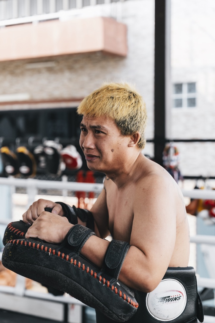 Thai pad holder waiting in the gym
