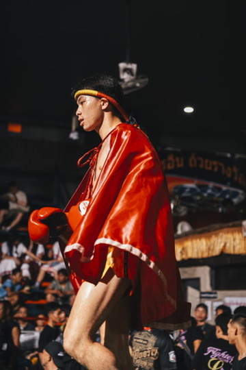 Fighter walking out in a red ceremonial cape